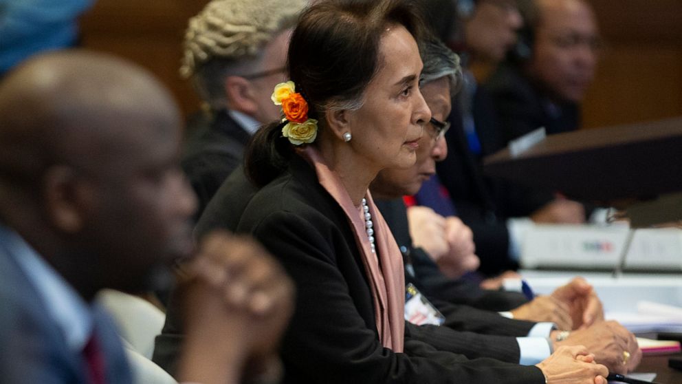Myanmar's leader Aung San Suu Kyi and Gambia's Justice Minister Aboubacarr Tambadou, left, listen to judges in the court room of the International Court of Justice for the first day of three days of hearings in The Hague, Netherlands, Tuesday, Dec. 1
