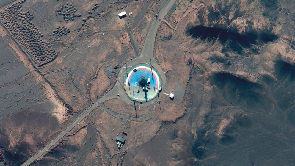 In this satellite photo from Maxar Technologies, trucks and other equipment surround a scorched launch pad at Iran's Imam Khomeini Spaceport in rural Semnan province Sunday, Feb. 27, 2022. Iran likely suffered another failed launch of a satellite-car