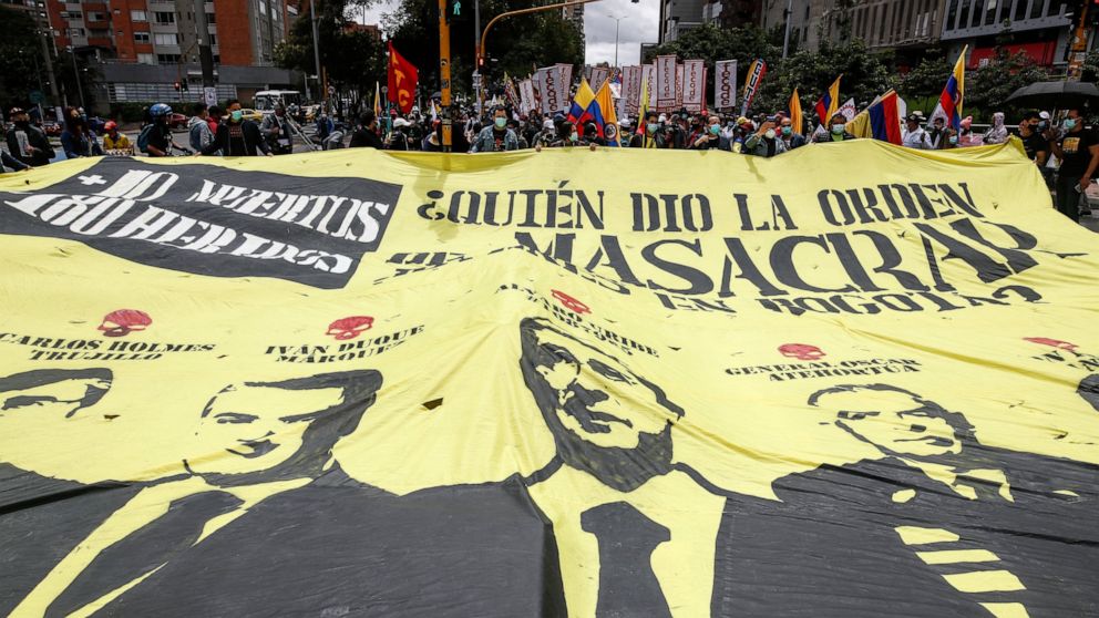 A giant banner that shows images of President Ivan Duque, former President Alvaro Uribe and Gen. Oscar Atehortua, with a message that asks in Spanish: "Who gave the order to massacre young people in Bogota," during an anti-government protest in Bogot