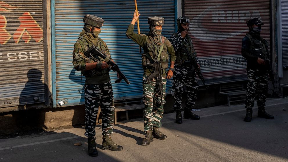 Paramilitary soldiers stand guard after chasing people who were protesting against sentencing of Kashmiri separatist leader Yasin Malik, in Srinagar, Indian controlled Kashmir, Wednesday, May 25, 2022. An Indian court sentenced a Kashmiri separatist 
