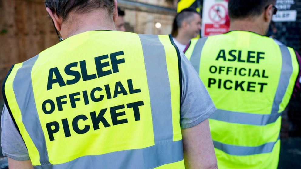 Aslef, Associated Society of Locomotive Engineers and Firemen members are pictured on a picket line at Willesden Junction station as members of the drivers union at nine train operators walk out for 24 hours over pay, in London, Saturday, Aug. 13, 20