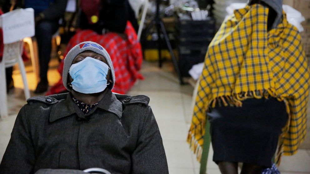 Election volunteers take a break during vote counting in Eldoret, Kenya, Wednesday, Aug. 10, 2022. Kenyans are waiting for the results of a close but calm presidential election in which the turnout was lower than usual. Tuesday's election was likely 