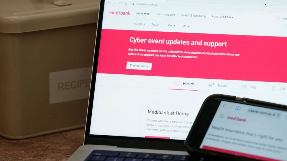 A computer and phone display pages from Medibank Private in Sydney, Tuesday, Nov. 8, 2022. Health insurer Medibank on Monday ruled out paying ransom for stolen customer data while a purported hacker responded on Tuesday by setting a 24-hour deadline 