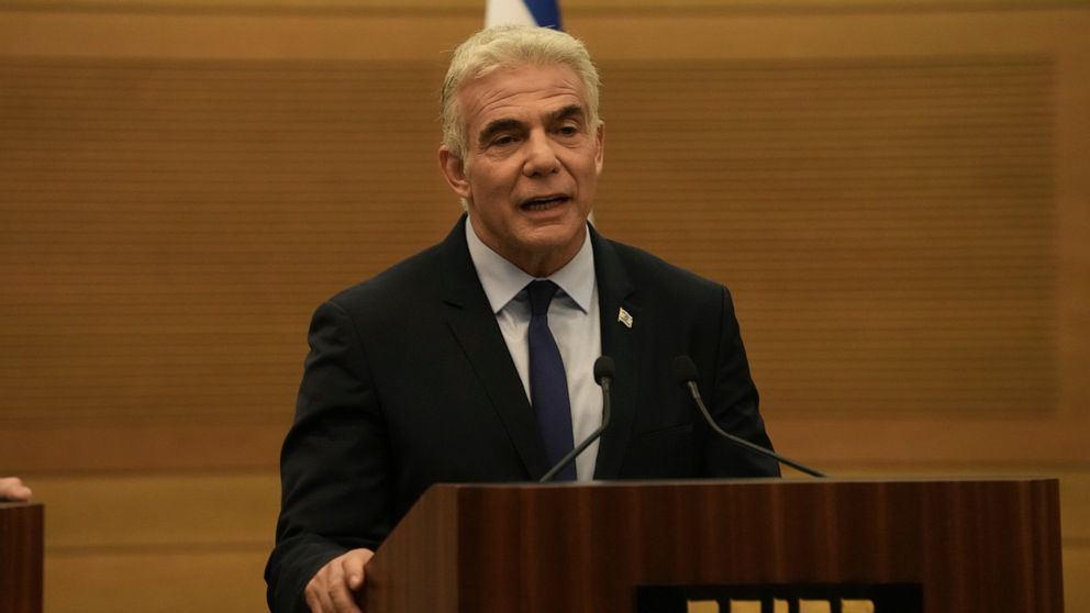 Israeli Foreign Minister Yair Lapid speaks during a joint statement with Prime Minister Naftali Bennett, at the Knesset, Israel's parliament, in Jerusalem, Monday, June 20, 2022. Bennett's office announced Monday, that his weakened coalition will be 