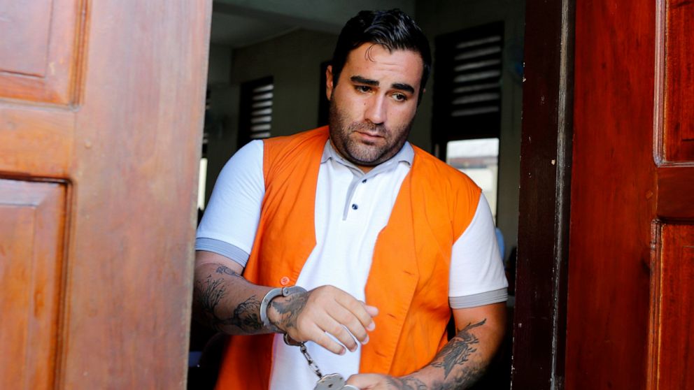 Ian Andrew Hernandez of California walks in handcuffs after his verdict trial in Bali, Indonesia on Monday, Jan. 13, 2020. An Indonesian judge has sentenced Hernandes to nine years and four months into prison for possessing and circulating 5 grams of
