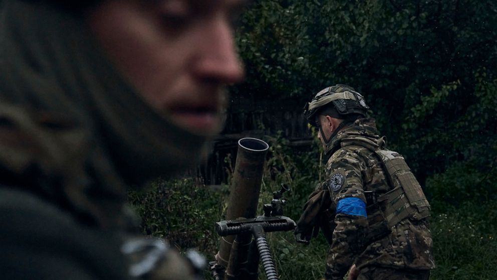 Ukrainian soldiers fire in the recently retaken city of Kupiansk, in the Kharkiv region, Ukraine, Friday, Sept. 23, 2022. Russian and Ukrainian forces exchanged missile and artillery barrages on Thursday as both sides refused to concede ground despit