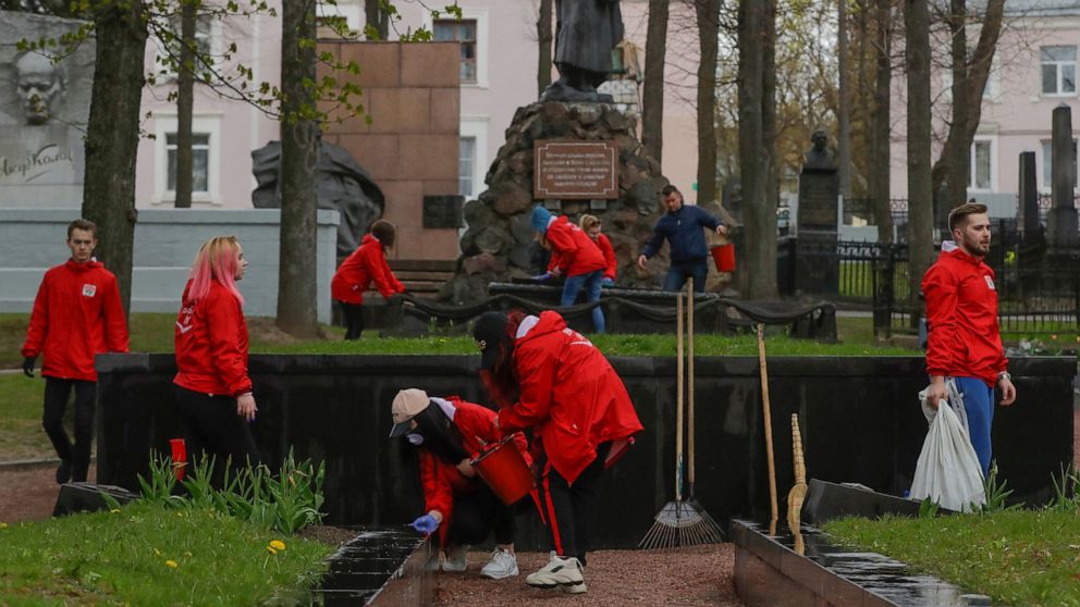 Members of the pro-government Belarussian Patriotic Union of Youth clean monuments on a military cemetery during a subbotnik, a Soviet-style Clean-up Day, in Minsk, Belarus, Saturday, April 25, 2020. Hundreds of thousands of state employees attend a 