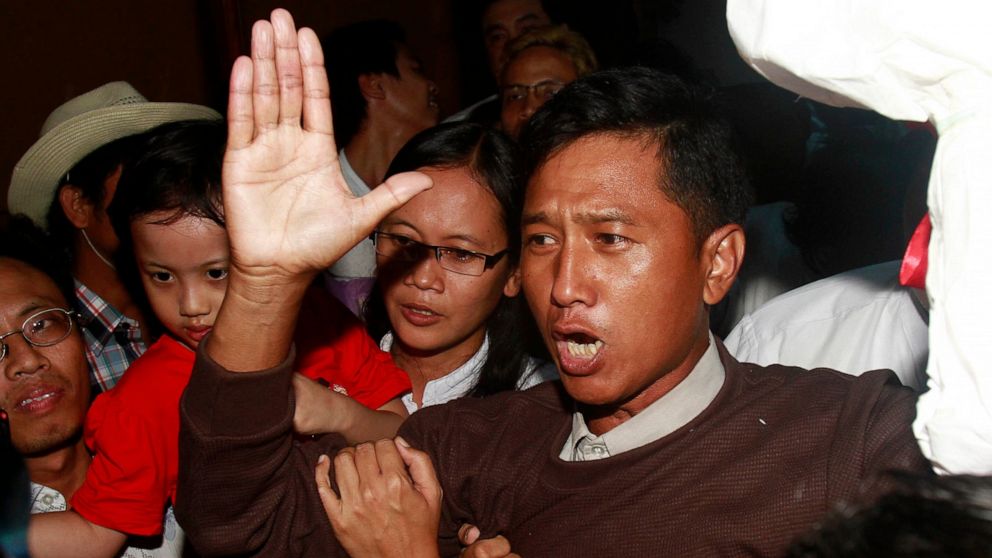 FILE - Kyaw Min Yu, a pro-democracy activist talks to journalists as he arrives at Yangon airport welcomed by his wife Nilar Thein, background, also an activist and his daughter after being released from a prison on Jan. 13, 2012, in Yangon. Myanmar 