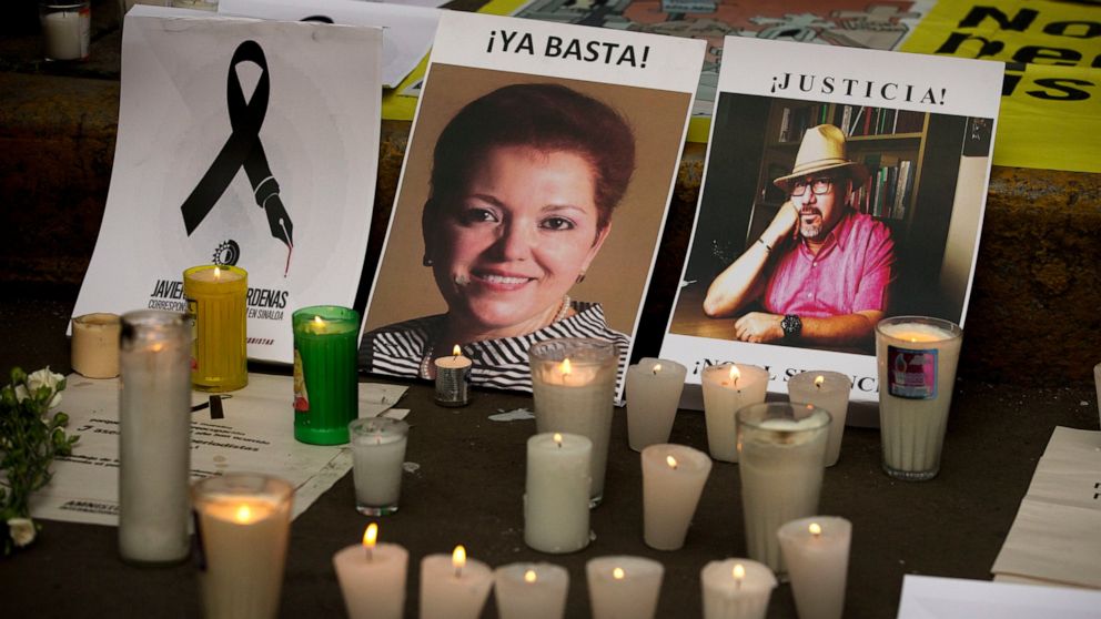 FLE - Candles burn in front of pictures of murdered journalists Miroslava Breach, left, and Javier Valdez during a demonstration against the killing of journalists, outside the Interior Ministry in Mexico City, May 16, 2017. A senior government human
