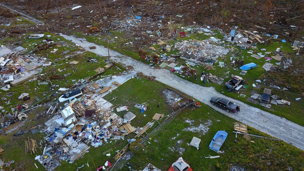 A road cuts through the rubble of homes that belong to the same family, destroyed by Hurricane Dorian in Rocky Creek East End, Grand Bahama, Bahamas, Sunday, Sept. 8, 2019. Bahamians are searching the rubble, salvaging the few heirlooms left intact b