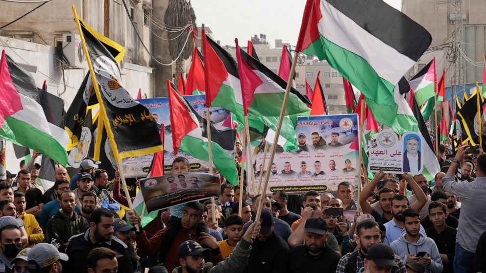 Islamic Jihad actives wave their national flags during a rally to mark Al-Quds, or Jerusalem, Day at the main road in Gaza City, Friday, April 29, 2022. (AP Photo/Adel Hana)