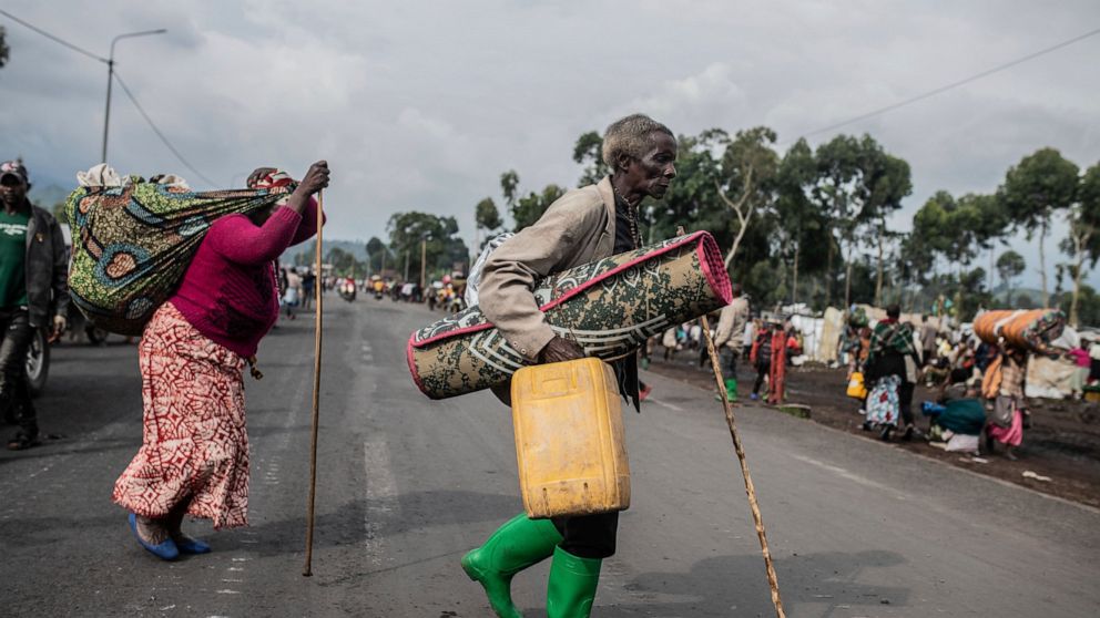 People fleeing the fighting between government forces and M-23 rebels make their way towards Goma, Democratic Republic of Congo, Tuesday Nov. 15, 2022. Violence by armed groups in eastern Congo has led to a diplomatic crisis between Congo and Rwanda,