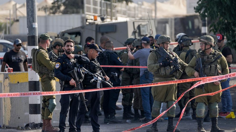 Israeli security forces examine the scene of a stabbing attack near the West Bank Jewish settlement of Kiryat Arba, next to the city of Hebron, Friday, Sept. 2, 2022. Israeli medics say a young Israeli man was stabbed and wounded in the occupied West