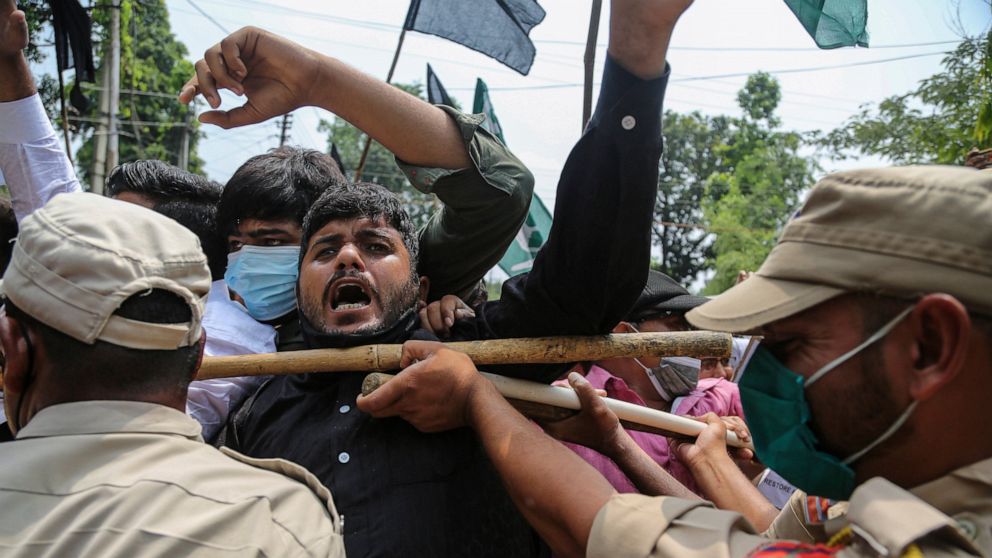 Activists of Peoples Democratic Party scuffle with police during a protest marking the second anniversary of Indian government scrapping Kashmir’s semi- autonomy in Jammu, India, Thursday, Aug.5, 2021. On Aug. 5, 2019, Indian government passed legisl