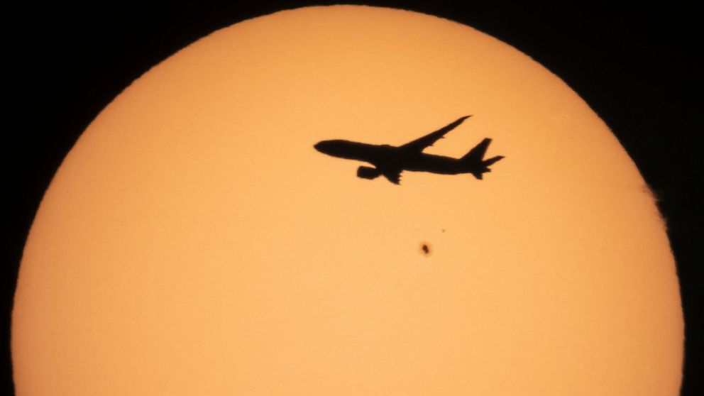 A cargo Boeing 777 of China Southern Airlines flying from Amsterdam to Shanghai is silhouetted against the sun as it flies over the village of Podolye, 70 kilometers (43 miles) east of St. Petersburg, Russia, on Oct. 11, 2021. An industry group repre