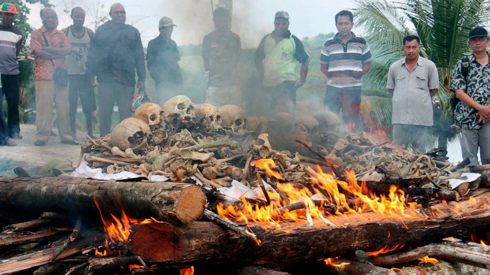People gather for the cremation ceremony for Japanese war dead in World War II, in Papua province, Indonesia, March, 2013. Seventy-five years after the end of World War II, more than 1 million Japanese war dead are scattered throughout Asia, where th