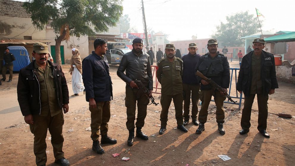 Pakistani police officers stand guard outside Multan jail after a court's decision for a professor facing blasphemy case, in Multan, Pakistan, Saturday, Dec. 21, 2019. A Pakistani court on Saturday convicted the Muslim professor of blasphemy, sentenc