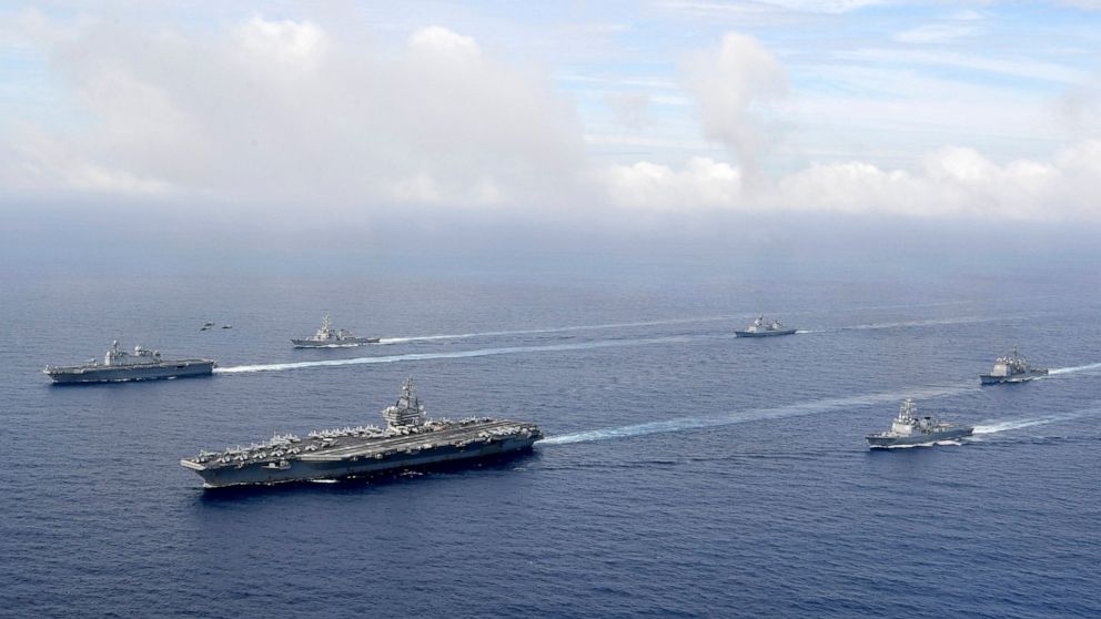 FILE - In this photo provided by South Korea's Defense Ministry, U.S. nuclear-powered aircraft carrier USS Ronald Reagan, second from left, and South Korea's landing platform helicopter (LPH) ship Marado, left, sail during a joint military exercise a