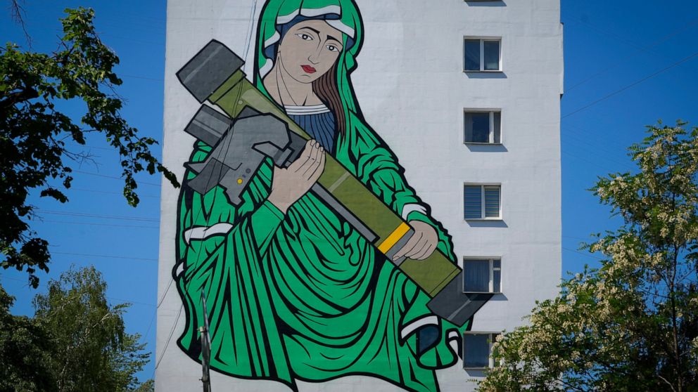 A mural depicts an image known as "Saint Javelina"- Virgin Mary cradling a US-made FGM-148 anti-tank weapon Javelin - on a living house wall in Kyiv, Ukraine, Monday, June 6, 2022. These missiles are among the arms being sent by Western allies to Ukr