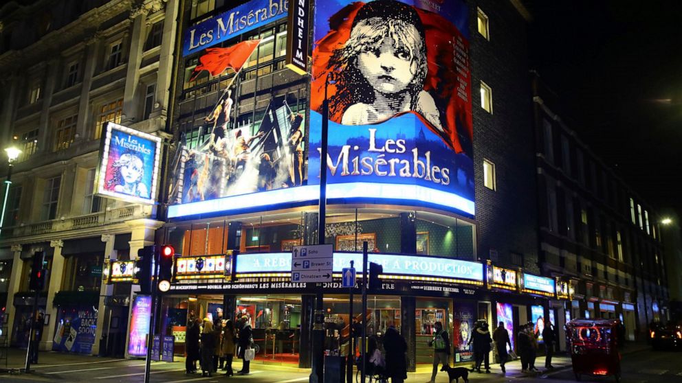 People leave the Sondheim Theatre, in London, where "Les Miserables" returned to the stage for the first time in almost nine months at the start of December, and now closes as London moves into the highest tier of coronavirus restrictions at midnight