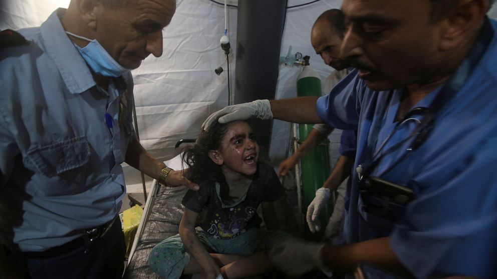 Medics treat a wounded girl at the al Najar hospital following an Israeli airstrike on their family building in Rafah, southern Gaza Strip, Saturday, Aug. 6, 2022. Israeli airstrikes have flattened homes in Gaza and Palestinian rocket barrages into s