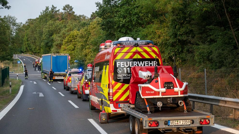Firefighting robots from the Vechta fire department stand near the scene of a fire in the Grunewald forest in Berlin, Germany, Friday, Aug.5, 2022. A fire accompanied by explosions at a police ammunition dump in a Berlin forest was contained and part