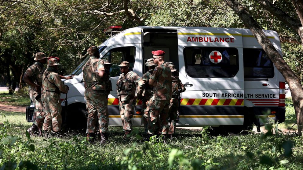 South African Military Health Services officers stationed outside the police station in Marianhill, near Durban, South Africa, Wednesday, April 20, 2022. Soldiers deployed to assist in security support, mop-up work, extraction, technical assessments,