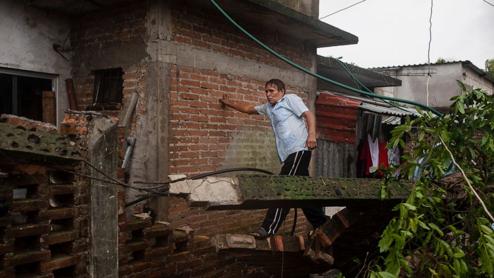 A man inspects the damage after a part of his home was toppled by the winds drought on by Hurricane Grace, in Tecolutla, Veracruz State, Mexico, Saturday, Aug. 21, 2021. Grace hit Mexico’s Gulf shore as a major Category 3 storm before weakening on Sa