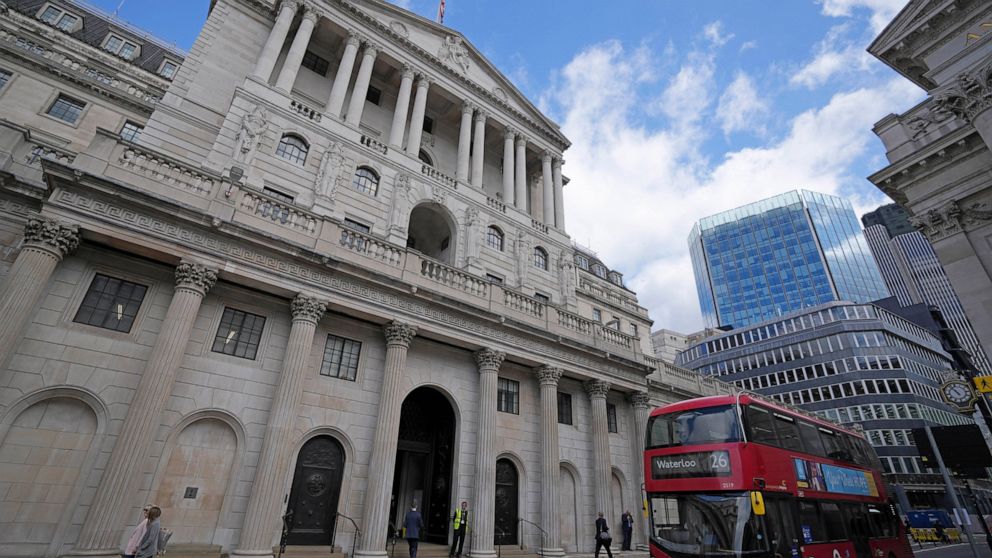 FILE - A bus drives past the Bank of England before the release of the Monetary Policy Report at the Bank of England in London, Thursday, May 5, 2022. The Bank of England is under pressure to raise interest rates more aggressively amid concern that t