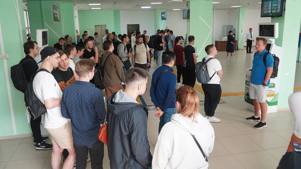 Russians lineup to get Kazakhstan's a Personal Identification Number (INN) in a public service center in Almaty, Kazakhstan, Tuesday, Sept. 27, 2022. A day after President Vladimir Putin ordered a partial mobilization to bolster his troops in Ukraine