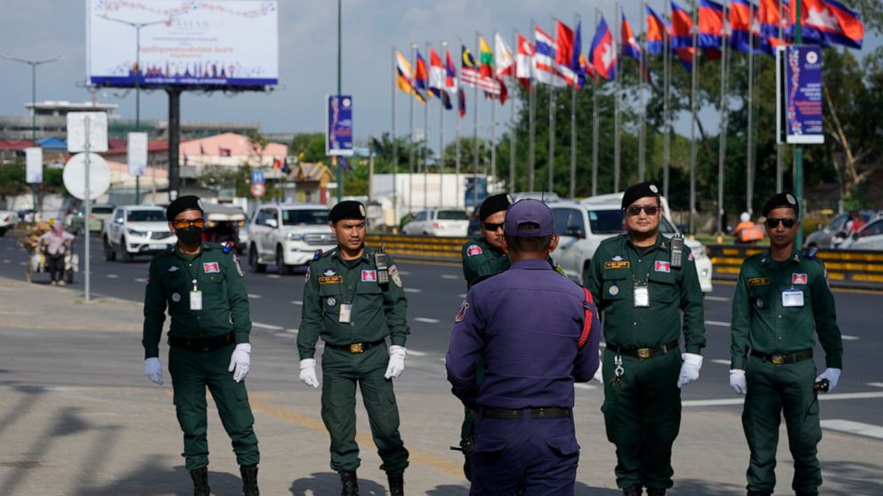 Police officers pose for a souvenir in a group photo as they guard near the Phnom Penh International Airport for the upcoming Association of Southeast Asian Nations (ASEAN) summits in Phnom Penh, Cambodia, Tuesday, Nov. 8, 2022. Southeast Asian leade