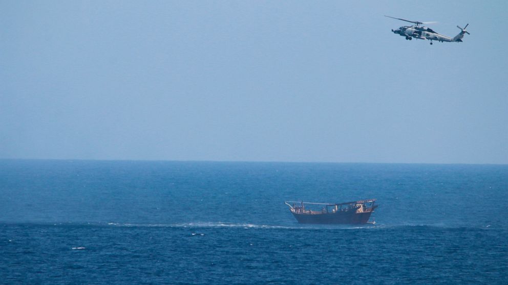 A U.S. Navy Seahawk helicopter flies over a stateless dhow later found to be carrying a hidden arms shipment in the Arabian Sea on Thursday, May 6, 2021. The U.S. Navy announced Sunday it seized the arms shipment hidden aboard the vessel in the Arabi