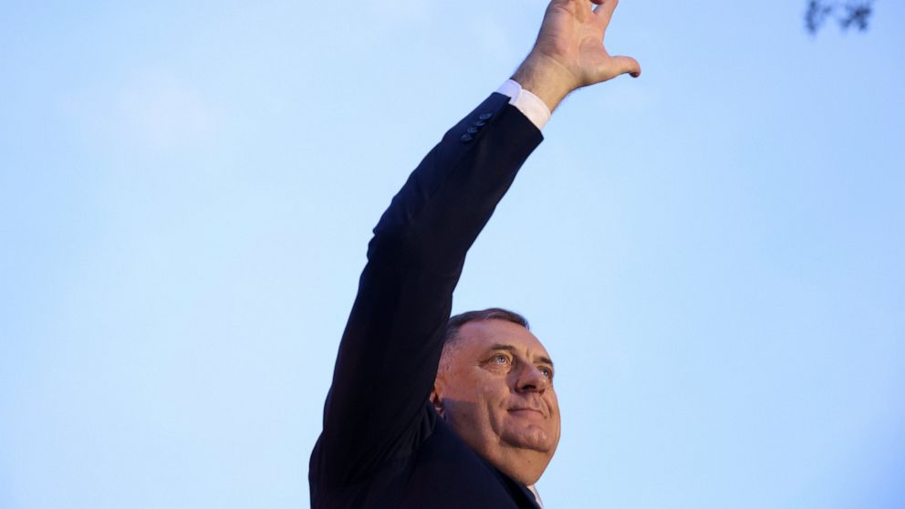 Bosnian Serb leader and member of the Bosnian Presidency Milorad Dodik waves with three fingers to the crowd of thousands who gathered to support the "people's rally for the defense of Republika Srpska" protest in Banja Luka, Bosnia, Tuesday, Oct. 25