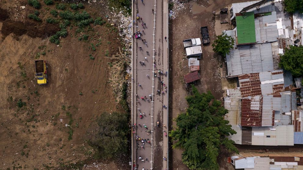 People use the Simon Bolivar International Bridge to cross from Cucuta, Colombia, in photo, to San Antonio, Venezuela, Friday, Aug. 5, 2022. The border has been partially closed for years by the Venezuelan government, and will gradually reopen after 