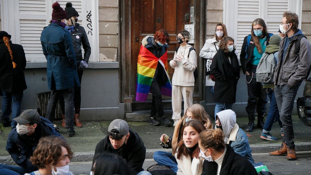 Students stage a sit-in outside the Fenelon High School in Lille, northern France, Friday, Dec. 18, 2020. About 100 teenagers rallied in northern France to pay homage to a transgender student who killed herself this week after facing tensions with sc