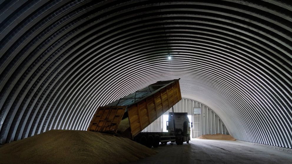 FILE - A dump track unloads grain in a granary in the village of Zghurivka, Ukraine, Aug. 9, 2022. A wartime agreement that allowed grain shipments from Ukraine to resume and helped temper global food prices will be extended by 120 days, the United N
