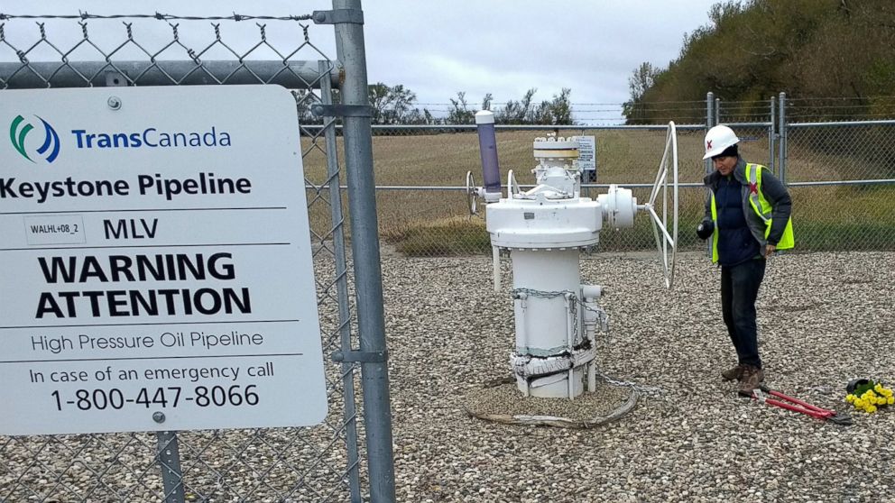 In this Oct. 11, 2016 photo provided by Samuel Jessup, climate change activist Michael Foster, of Seattle, turns an emergency shut-off valve on an oil pipeline in northeastern North Dakota. Foster was arrested and ended up spending six months in jail