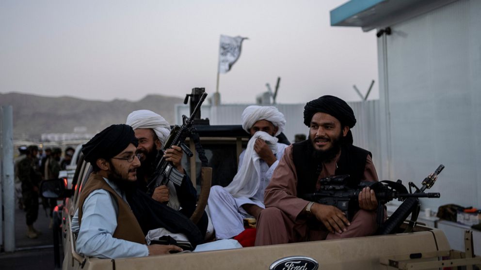 Taliban fighters sit in a pickup truck at the airport in Kabul, Afghanistan, Thursday, Sept. 9, 2021. Some 200 foreigners, including Americans, flew out of Afghanistan on an international commercial flight from Kabul airport on Thursday, the first su