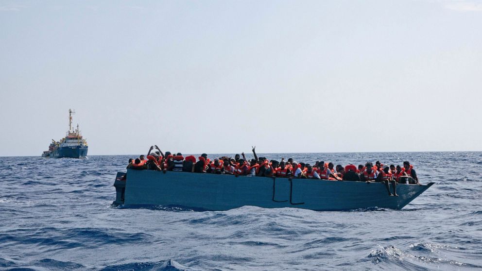 After days at sea, some migrants reach Italy, others wait