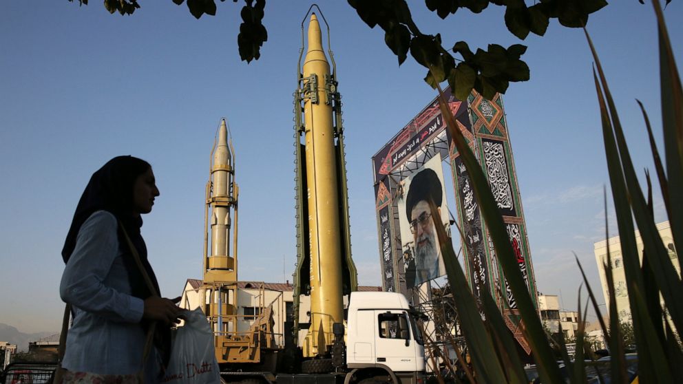 FILE - A Ghadr-H missle, center, a solid-fuel surface-to-surface Sejjil missile and a portrait of the Supreme Leader Ayatollah Ali Khamenei are on display for the annual Defense Week, marking the 37th anniversary of the 1980s Iran-Iraq war, at Bahare
