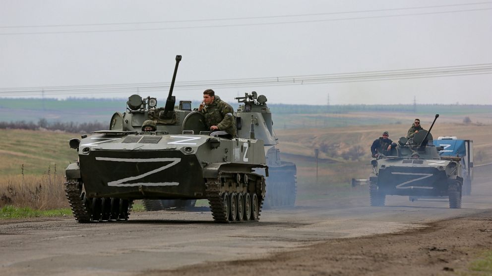 FILE - Russian military vehicles move on a highway in an area controlled by Russian-backed separatist forces near Mariupol, Ukraine, April 18, 2022. (AP Photo/Alexei Alexandrov, File)