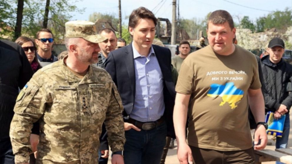 This image provided by the Irpin Mayor's Office shows Canadian Prime Minister Justin Trudeau walking with mayor Oleksandr Markushyn, right, in Irpin, Ukraine, Sunday, May 8, 2022. Trudeau made a surprise visit to Irpin on Sunday. The city was severel