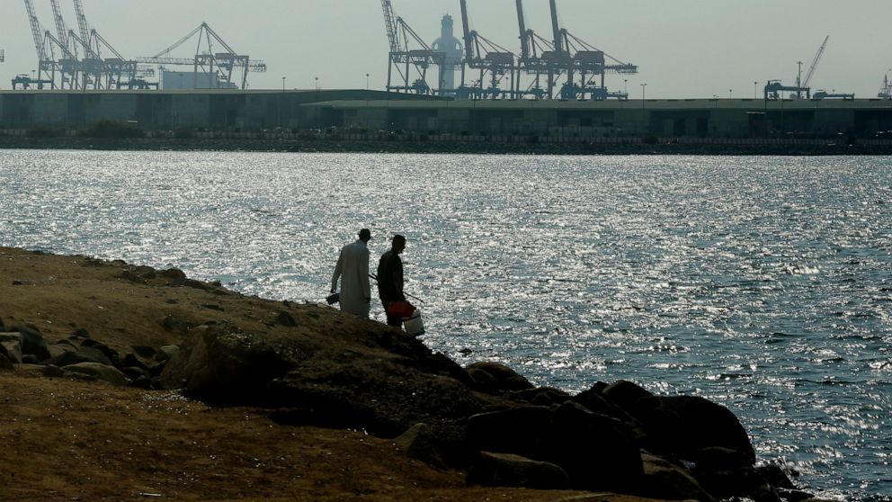 Visitors prepare to fish in front of the Red Sea port, in Jiddah, Saudi Arabia, Monday, Dec.14, 2020. An explosion rocked a ship off Saudi Arabia's port city of Jiddah on the Red Sea, authorities said Monday, without elaborating. (AP Photo/Amr Nabil)