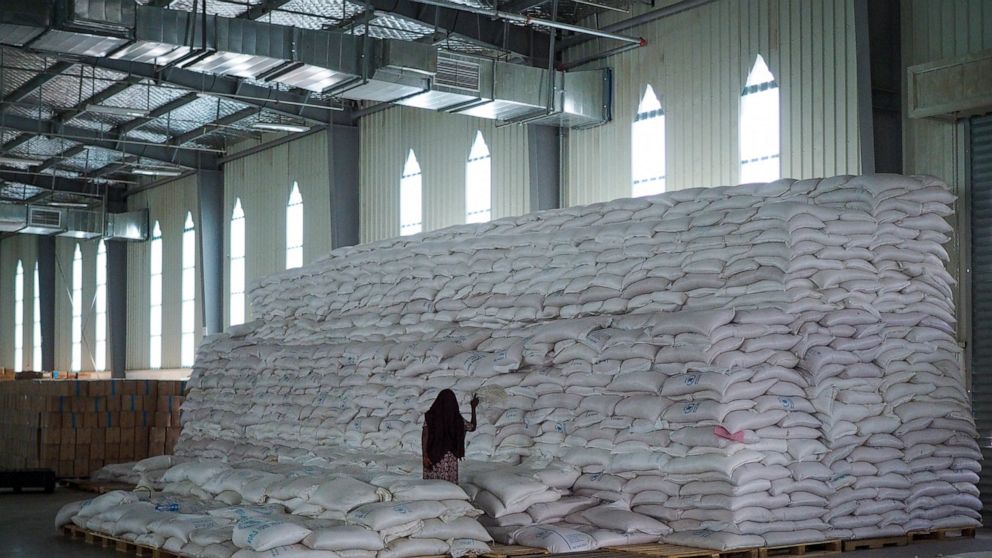FILE - A worker walks next to a pile of sacks of food earmarked for the Tigray and Afar regions in a warehouse of the World Food Programme (WFP) in Semera, the regional capital for the Afar region, in Ethiopia on Feb. 21, 2022. The European Union sai