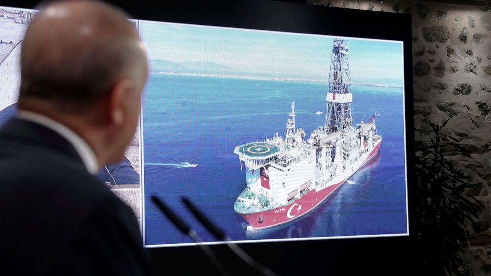 Turkey's President Recep Tayyip Erdogan speaks with Turkish drilling ship, Fatih, in the background, in Istanbul, Friday, Aug. 21, 2020. Erdogan has announced the discovery of a large natural gas reserves off the Black Sea coast, days after he promis