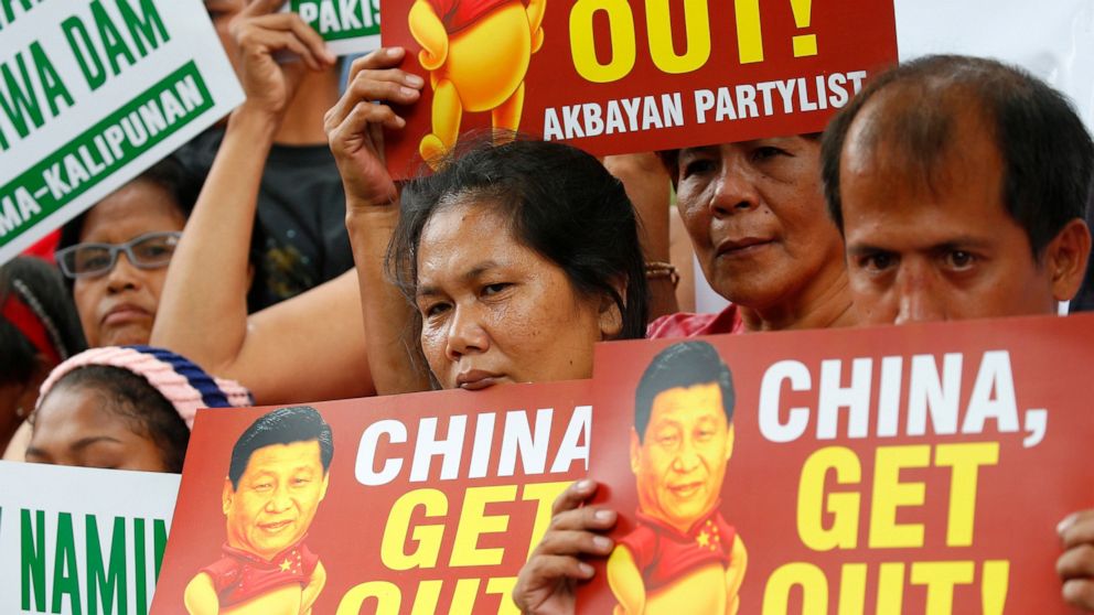 FILE - In this Nov. 21, 2018, file photo, demonstrators rally outside the Chinese Consulate to protest the two-day state visit in the country of President Xi Jinping in Manila, Philippines. The Philippines on Wednesday, April 22, 2020, has protested 