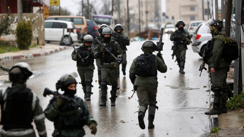 FILE - In this Wednesday, Jan. 9, 2019 file photo, Israeli forces deploy during a raid in the West Bank City of Ramallah. Israel has been launching raids into the heart of Ramallah, and the U.S. is cutting off aid and taking actions that many fear wi