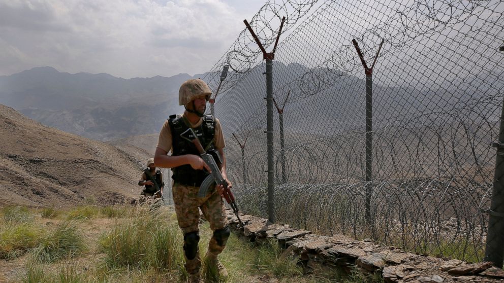 FILE - In this Aug. 3, 2021 file photo, Pakistan Army troops patrol along the fence on the Pakistan Afghanistan border at Big Ben hilltop post in Khyber district, Pakistan. The Taliban win in Afghanistan is giving a boost to militants in neighboring 