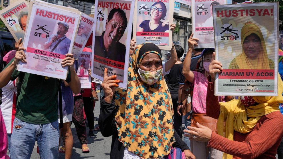 Protesters hold pictures of alleged victims of extra-judicial killings during a rally outside the Malacanang palace in Manila, Philippines on Wednesday, June 30, 2021. The group has called for justice and accountability for the thousands who have die