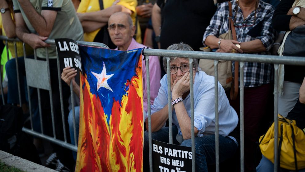 A protester holds a placard during a demonstration to commemorate the fifth anniversary of an independence referendum that marked the high point of their movement to break away from the rest of Spain, in Barcelona, Spain, Saturday, Oct. 1, 2022. (AP 